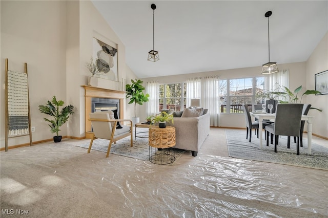 living room featuring a tile fireplace and high vaulted ceiling