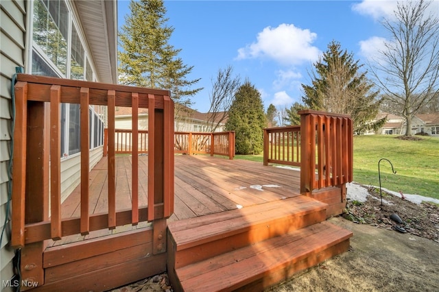 wooden deck featuring a yard