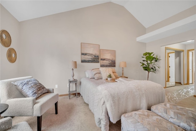 bedroom with vaulted ceiling and light colored carpet