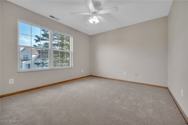 carpeted empty room featuring ceiling fan