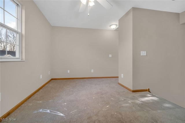 spare room featuring carpet floors and ceiling fan