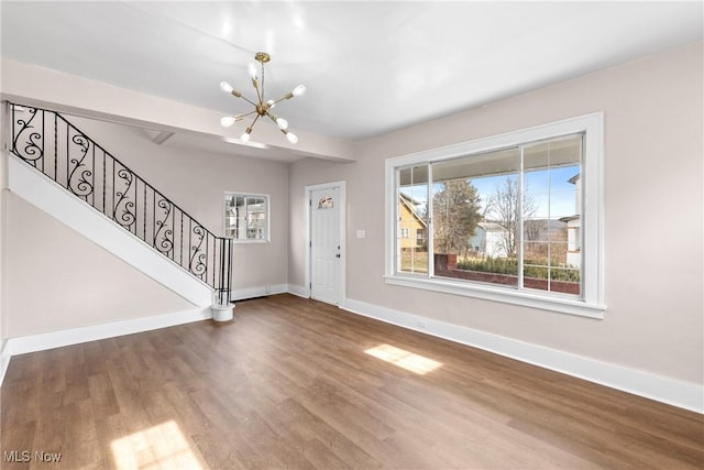 foyer with hardwood / wood-style flooring and a chandelier