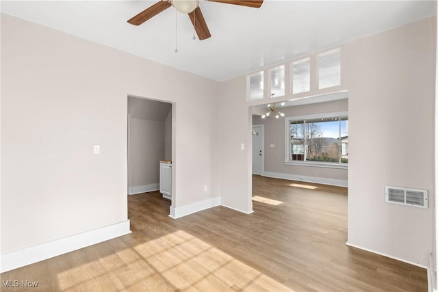 unfurnished living room with hardwood / wood-style flooring and ceiling fan