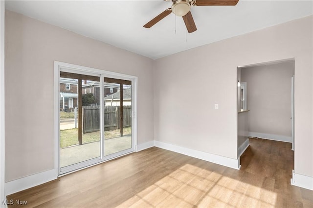 empty room with hardwood / wood-style floors and ceiling fan