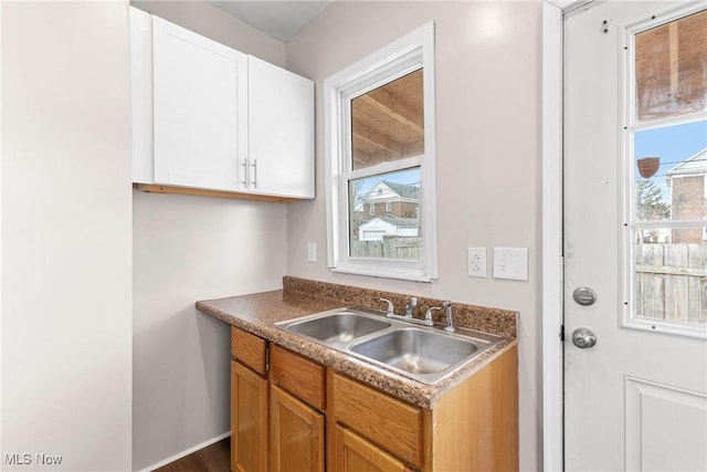 kitchen featuring sink, a wealth of natural light, and white cabinets