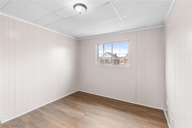 spare room with crown molding and wood-type flooring