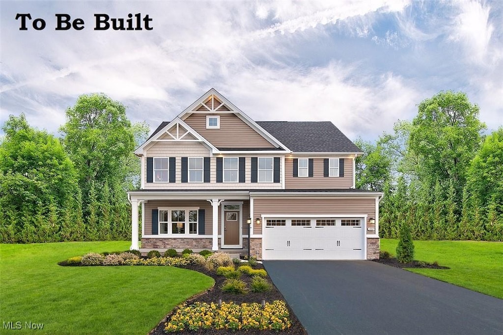 craftsman-style house featuring a garage and a front lawn