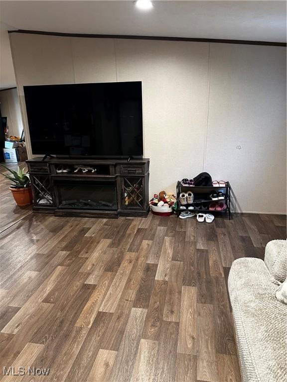 living room featuring crown molding and wood-type flooring
