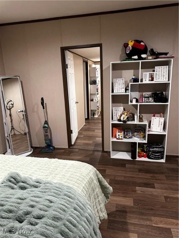 bedroom with dark wood-type flooring