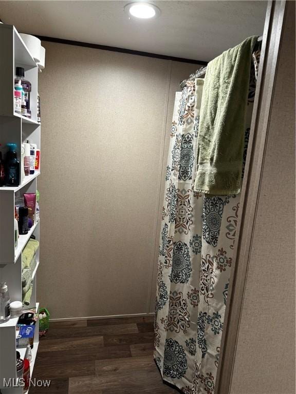 bathroom with hardwood / wood-style flooring and curtained shower