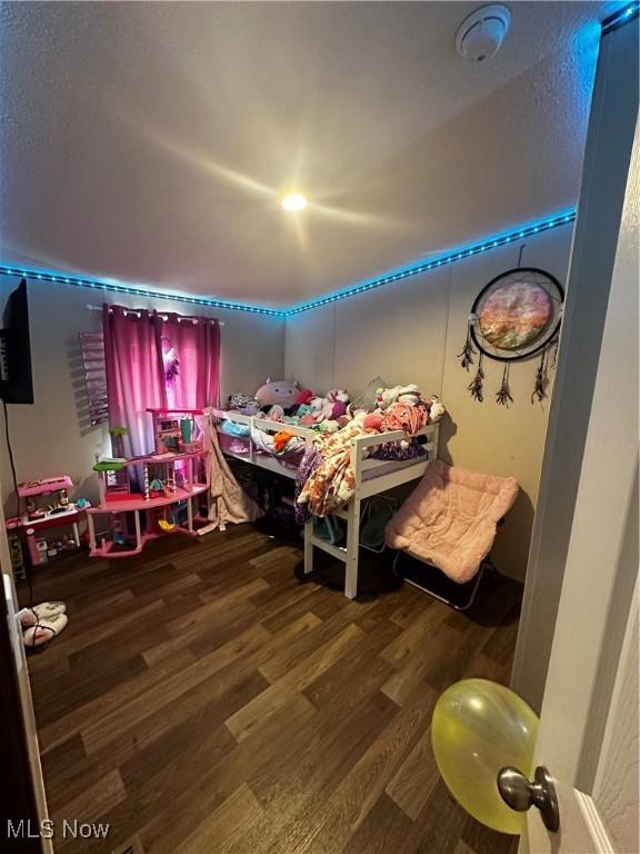 bedroom with dark wood-type flooring