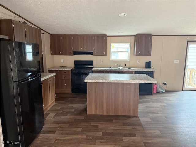 14000 Lincoln St SE, Minerva, OH 44657 - kitchen featuring black appliances, range hood, dark wood-style floors, light countertops, and a center island