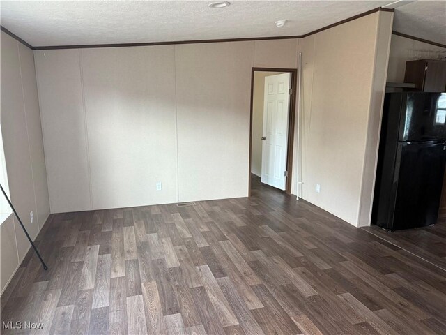 14000 Lincoln St SE, Minerva, OH 44657 - empty room with ornamental molding, dark wood-style floors, a textured ceiling, a decorative wall, and a smoke detector