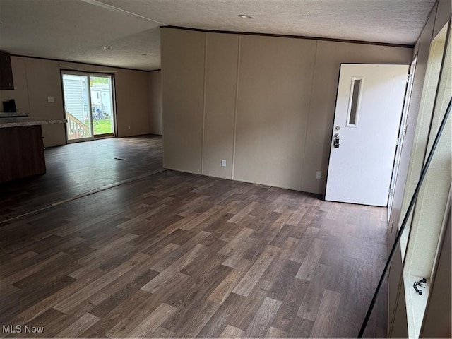 14000 Lincoln St SE, Minerva, OH 44657 - unfurnished living room featuring dark wood-type flooring and a textured ceiling