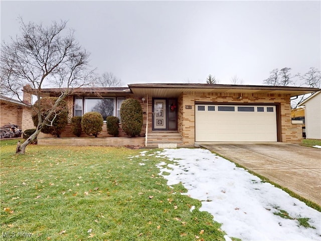 view of front of property featuring a garage and a yard