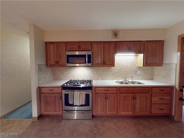 kitchen with stainless steel appliances, sink, and decorative backsplash