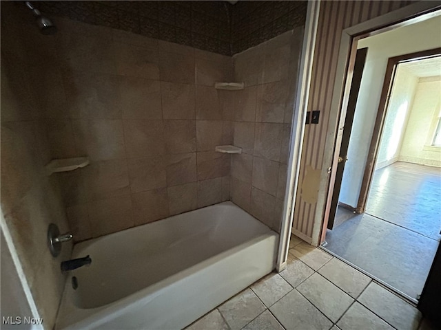 bathroom with tile patterned flooring and tiled shower / bath