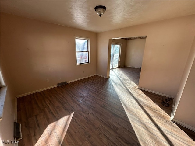 unfurnished room featuring dark hardwood / wood-style flooring