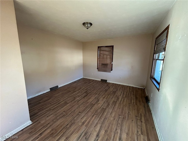 unfurnished room featuring dark wood-type flooring