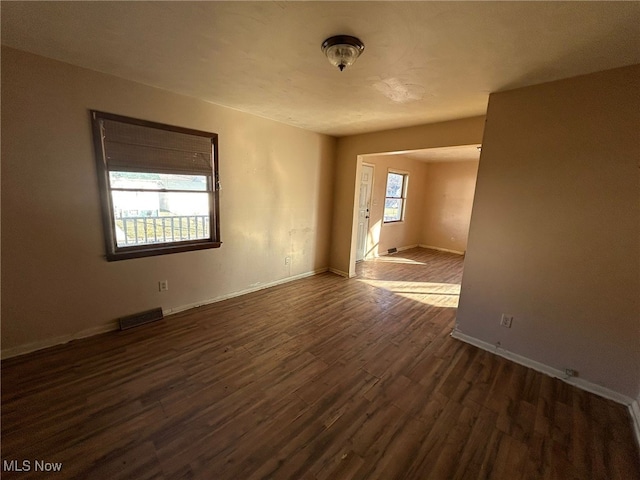 spare room featuring dark hardwood / wood-style flooring