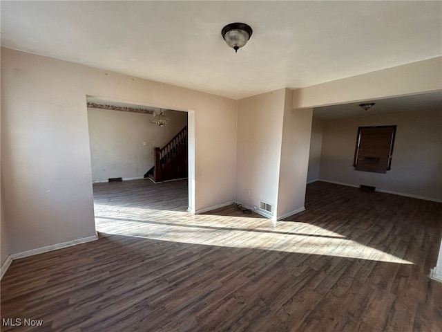 empty room with dark wood-type flooring