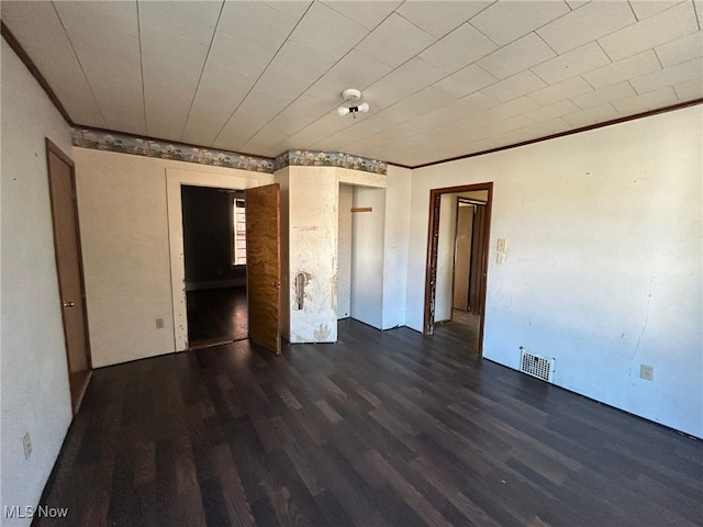 interior space with ornamental molding and dark hardwood / wood-style flooring