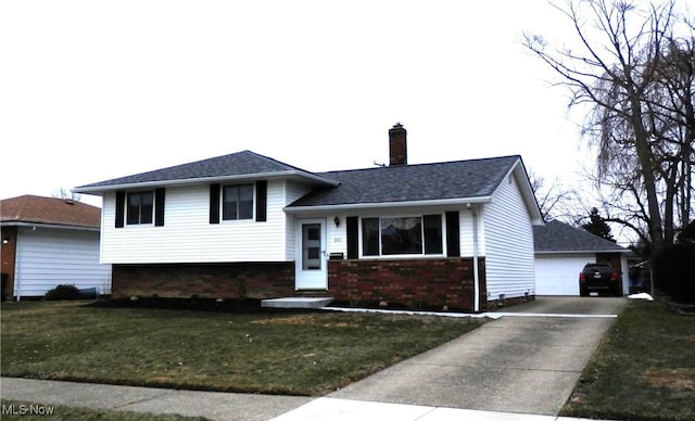 split level home featuring a garage and a front lawn