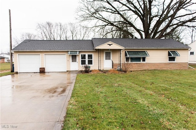 single story home with a wall unit AC, a garage, and a front yard