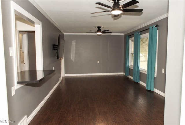 empty room featuring dark hardwood / wood-style flooring and crown molding