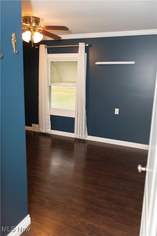 empty room featuring crown molding, ceiling fan, and hardwood / wood-style flooring