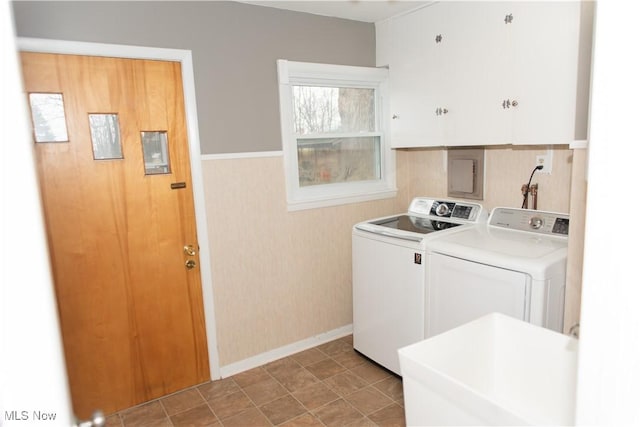 laundry room featuring cabinets and washer and clothes dryer