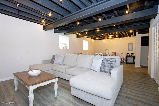 living room featuring wood-type flooring, beam ceiling, electric panel, and rail lighting