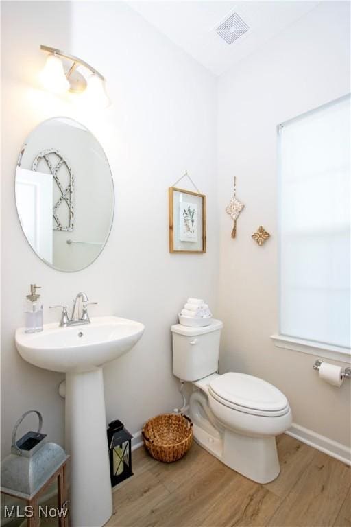 bathroom featuring hardwood / wood-style floors and toilet