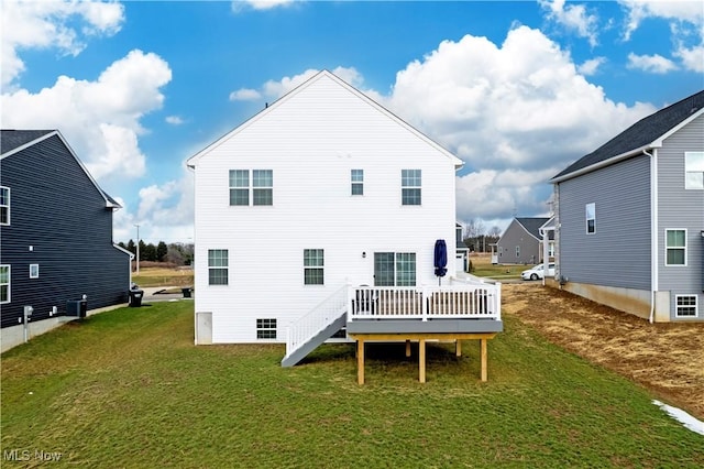 back of house featuring a wooden deck and a yard