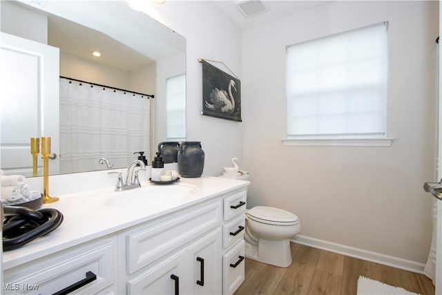 bathroom featuring vanity, toilet, and wood-type flooring