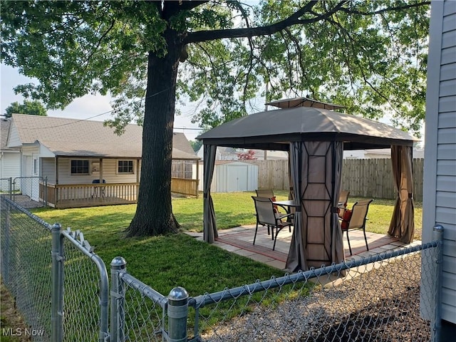 view of yard featuring a gazebo, a patio area, and a storage unit