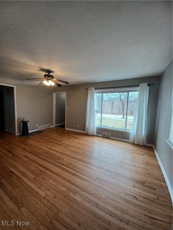 unfurnished living room with ceiling fan and light hardwood / wood-style flooring