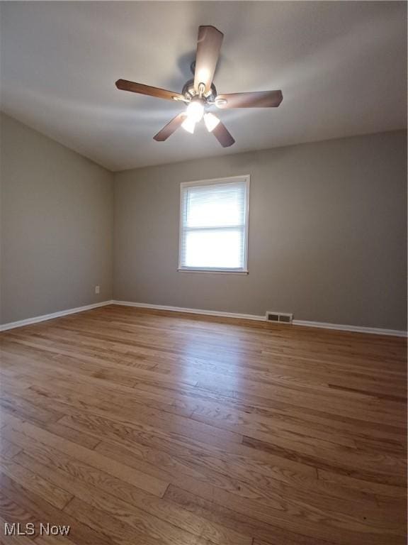 spare room featuring hardwood / wood-style flooring and ceiling fan