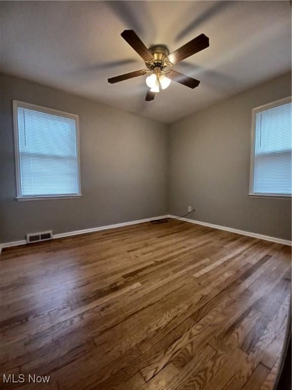 empty room featuring wood-type flooring and ceiling fan