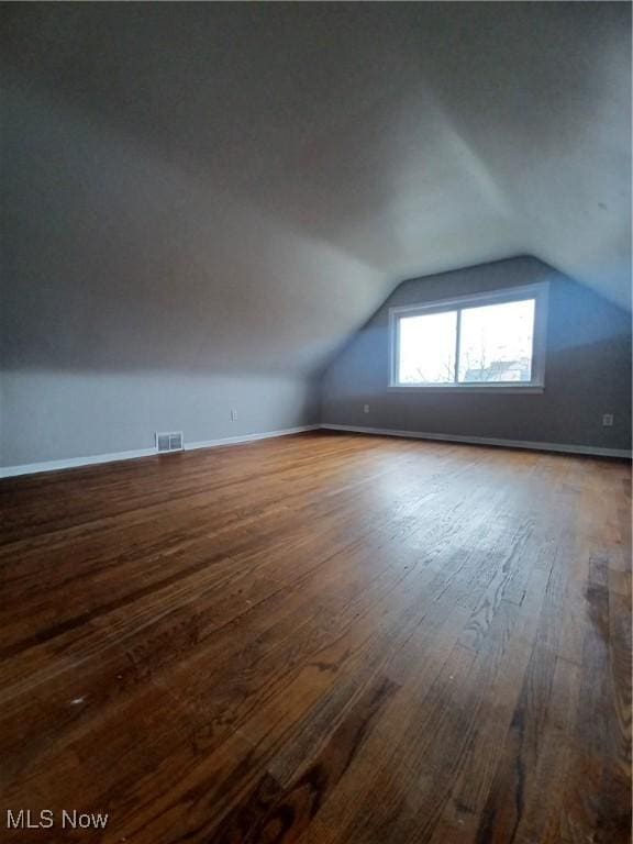 bonus room featuring vaulted ceiling and hardwood / wood-style floors