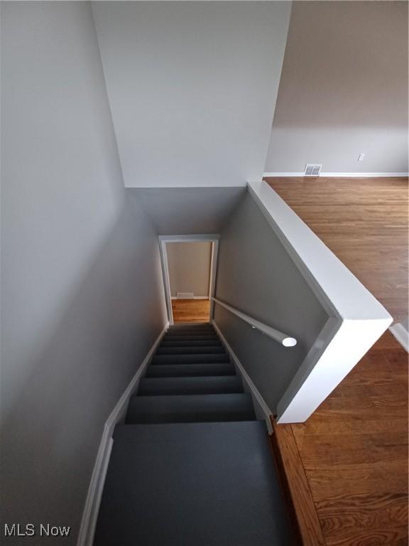 stairs with wood-type flooring