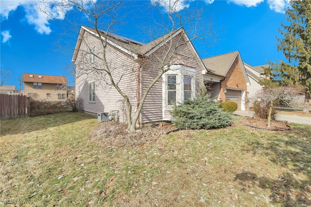 view of front of property featuring a garage and a front yard