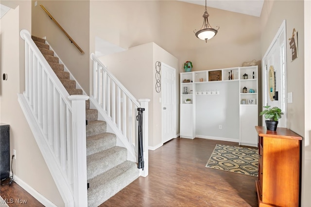 entryway featuring dark hardwood / wood-style floors and a high ceiling