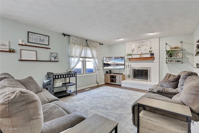 living room with hardwood / wood-style flooring and a fireplace