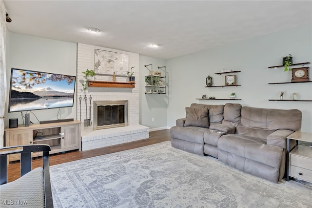 living room featuring dark hardwood / wood-style flooring and a fireplace