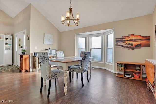 dining space with dark wood-type flooring, a chandelier, and vaulted ceiling