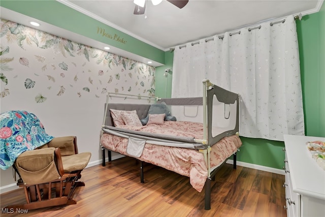 bedroom with crown molding, wood-type flooring, and ceiling fan