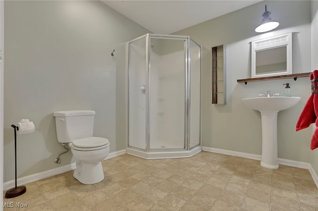 bathroom featuring toilet and an enclosed shower