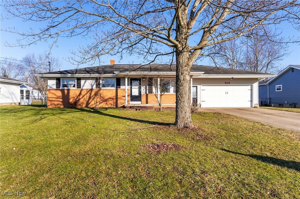 ranch-style home featuring a garage and a front lawn