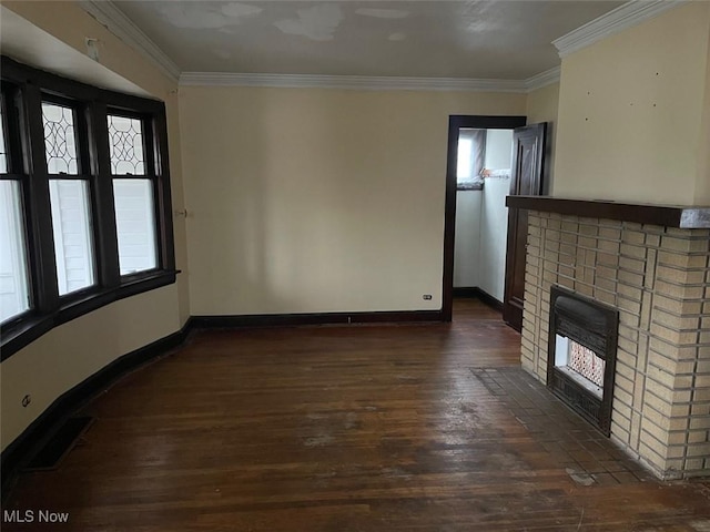 unfurnished living room featuring crown molding, dark wood-type flooring, and a fireplace